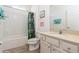 Bright bathroom with a shower-tub combo, vanity with granite countertop, and stylish decor at 7017 Oakwood St, Davenport, FL 33837