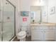 Bathroom featuring a glass enclosed shower, neutral vanity, and modern fixtures at 7017 Oakwood St, Davenport, FL 33837
