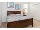 Bedroom features a wood frame bed, with double door closet and a window at 7017 Oakwood St, Davenport, FL 33837