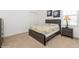Bedroom with a modern bed frame, neutral carpet, and natural light from the window at 7017 Oakwood St, Davenport, FL 33837