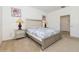 Bedroom with a padded headboard, neutral bedding, and convenient ensuite access at 7017 Oakwood St, Davenport, FL 33837