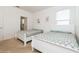 Bedroom featuring two beds, soft carpet, white trim and neutral walls at 7017 Oakwood St, Davenport, FL 33837