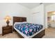 Comfortable bedroom with floral bedding, wooden furniture, and an adjacent bathroom at 7017 Oakwood St, Davenport, FL 33837