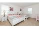 Inviting bedroom featuring two beds, carpeted floors, and white wood furniture at 7017 Oakwood St, Davenport, FL 33837