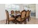 Elegant dining room with ornate table, chairs, and natural light streaming through large windows at 7017 Oakwood St, Davenport, FL 33837