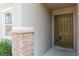 Inviting front entrance featuring stone accents, a green front door and a window at 7017 Oakwood St, Davenport, FL 33837