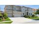 Attractive two-story home with a large driveway and well-maintained landscaping at 7017 Oakwood St, Davenport, FL 33837