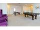 Large game room with a pool table, foosball, and cozy seating at 7017 Oakwood St, Davenport, FL 33837