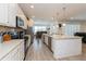 This open kitchen features stainless steel appliances, a large island, and ample counter space at 7017 Oakwood St, Davenport, FL 33837