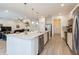 Bright kitchen boasts stainless appliances, center island, and open-concept layout perfect for entertaining at 7017 Oakwood St, Davenport, FL 33837