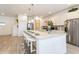 Stylish kitchen featuring a large center island with seating and stainless-steel appliances at 7017 Oakwood St, Davenport, FL 33837