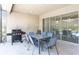 Outdoor patio with dining table, chairs, and a grill, perfect for entertaining guests at 7017 Oakwood St, Davenport, FL 33837