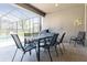 Outdoor patio area featuring a dining table, chairs, and a grill; ideal for entertaining at 7017 Oakwood St, Davenport, FL 33837