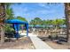 Inviting pool area with ample seating, cabanas, and lush palm trees, creating a resort-like atmosphere at 7017 Oakwood St, Davenport, FL 33837