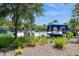 A pristine pool with lush landscaping, shaded cabanas, and a Personal walking through the water at 7017 Oakwood St, Davenport, FL 33837