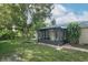 The home has a backyard with an enclosed patio, with beautiful greenery and trees at 708 Wilson Rd, Winter Springs, FL 32708