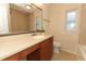 Bathroom featuring a long vanity, an undermount sink, and a large framed mirror at 708 Wilson Rd, Winter Springs, FL 32708