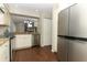 Bright kitchen showcasing a stainless steel refrigerator and view into adjacent dining area at 708 Wilson Rd, Winter Springs, FL 32708