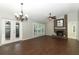 Bright living room with hardwood floors, fireplace, and French doors to the outdoors at 708 Wilson Rd, Winter Springs, FL 32708