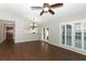 Open living space with hardwood floors, vaulted ceiling, and natural light from French doors at 708 Wilson Rd, Winter Springs, FL 32708