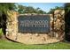 Entrance sign for Wedgewood Tennis Villas community featuring stone accents at 708 Wilson Rd, Winter Springs, FL 32708