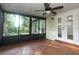 Sunroom featuring tile floors, white trim, a ceiling fan, and several windows overlooking the backyard at 708 Wilson Rd, Winter Springs, FL 32708