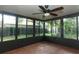 Enclosed sunroom featuring tile flooring and a ceiling fan for added comfort at 708 Wilson Rd, Winter Springs, FL 32708