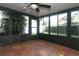 Sunroom with tile flooring, multiple windows, and a ceiling fan at 708 Wilson Rd, Winter Springs, FL 32708
