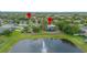 Aerial view of neighborhood amenities including a playground and a pond with a fountain at 714 Home Grove Dr, Winter Garden, FL 34787