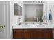 Bathroom with a double sink vanity, modern lighting, and a neutral color scheme at 714 Home Grove Dr, Winter Garden, FL 34787