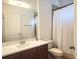 Bright bathroom featuring a single sink vanity with white countertop and a shower with white curtain at 714 Home Grove Dr, Winter Garden, FL 34787