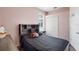 Cozy bedroom with a pink wall, closet and a window providing natural light at 714 Home Grove Dr, Winter Garden, FL 34787
