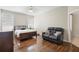 The bedroom features a cozy seating area and plenty of natural light from two large windows at 714 Home Grove Dr, Winter Garden, FL 34787