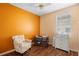 Inviting bedroom with a chair, changing table, dresser and large window creating a comfortable space at 714 Home Grove Dr, Winter Garden, FL 34787