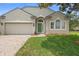Charming single-story home featuring a well-manicured lawn and a neutral stucco exterior with a green front door at 714 Home Grove Dr, Winter Garden, FL 34787