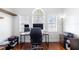 Well-lit home office showcasing a large window, a computer setup, and an ergonomic chair on hardwood flooring at 714 Home Grove Dr, Winter Garden, FL 34787