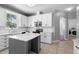 Updated kitchen boasts white cabinets, stainless appliances, an island, subway tile backsplash and modern finishes at 714 Home Grove Dr, Winter Garden, FL 34787