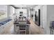 Spacious kitchen with white cabinets, stainless steel appliances, a dining table with bench seating and tile floors at 714 Home Grove Dr, Winter Garden, FL 34787