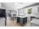Bright, open-concept kitchen with a central island, white cabinetry, stainless steel appliances and a dining area at 714 Home Grove Dr, Winter Garden, FL 34787