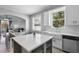 Bright kitchen with white cabinets, stainless appliances, an island with storage, open to the dining and living spaces at 714 Home Grove Dr, Winter Garden, FL 34787