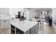 Open kitchen featuring white cabinets, stainless steel appliances, an island with seating, and a view of the dining area at 714 Home Grove Dr, Winter Garden, FL 34787