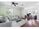 Open living space boasting hardwood floors, neutral paint, a ceiling fan and filled with ample natural light at 714 Home Grove Dr, Winter Garden, FL 34787