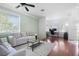 Open living space boasting hardwood floors, neutral paint, a ceiling fan and filled with ample natural light at 714 Home Grove Dr, Winter Garden, FL 34787