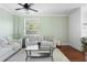 Bright living room featuring hardwood floors, neutral paint, a ceiling fan and filled with ample natural light at 714 Home Grove Dr, Winter Garden, FL 34787
