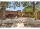 Paver patio seating area with a grill, shaded by mature trees and string lights at 714 Home Grove Dr, Winter Garden, FL 34787