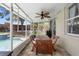 Enclosed patio area with stone floors, a dining table, and a view of the pool and well-maintained backyard at 714 Home Grove Dr, Winter Garden, FL 34787