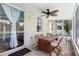Covered patio with tile flooring, a ceiling fan, and a dining table with chairs, leading to the pool area at 714 Home Grove Dr, Winter Garden, FL 34787