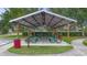 Community picnic area with picnic tables, trash cans, and a shelter at 714 Home Grove Dr, Winter Garden, FL 34787