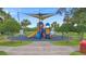 A playground for the community includes a colorful play structure, benches, and shade at 714 Home Grove Dr, Winter Garden, FL 34787