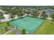 Aerial view of the community tennis courts surrounded by a fence and landscaping at 714 Home Grove Dr, Winter Garden, FL 34787